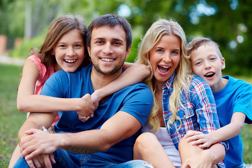 Smiling family portrait that reinforces One Grand Unity's people-first brand